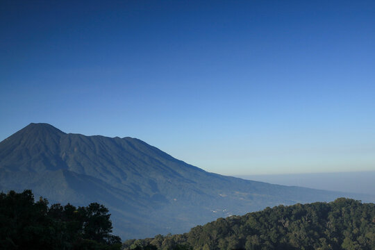 Majestic mountain dominates a serene, clear sky