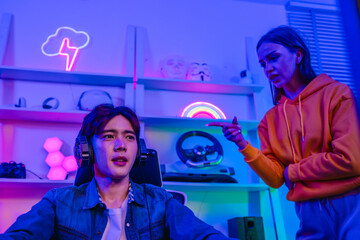 Upset girlfriend complaining to excited boyfriend gamer who laughs while playing video games © SpaceOak