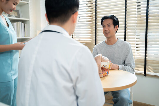 Neurologist explaining brain scan results and conducting physical movement response test with patient in medical clinic,representing healthcare,neurology diagnosis,Health care and technology.