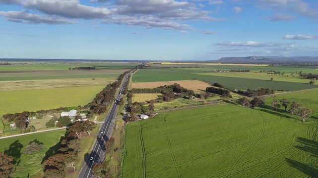 Aerial drone view of along the Western Highway near Horsham, Victoria, Australia. The rural localities of Bungalally with vast agricultural crop fields stretching toward Mount Stapylton. 
