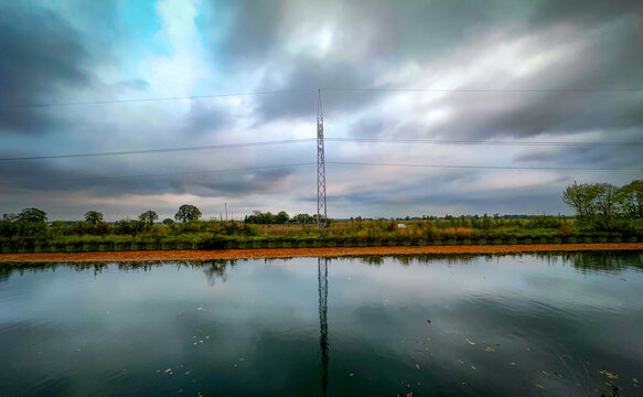 Pastoral view features water display and infrastructure present
