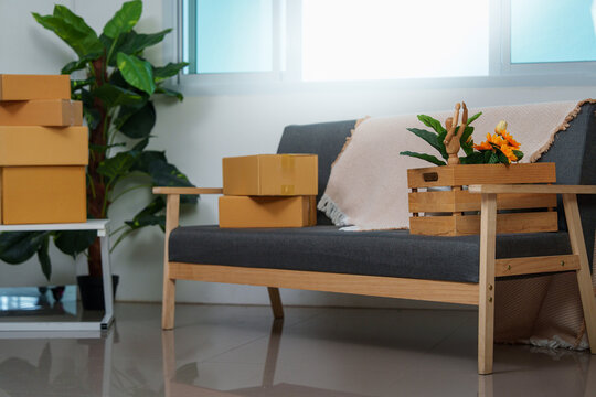 Living room interior with stacked cardboard boxes and sofa for moving concept