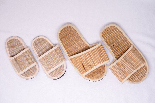 Traditional bamboo slippers for casual wear on white background