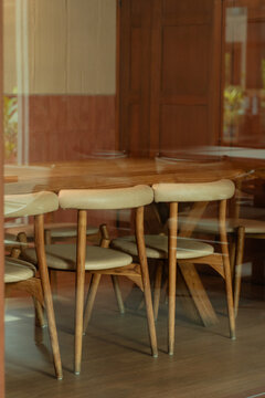 Empty wooden dining chairs in cozy restaurant setting for hospitality
