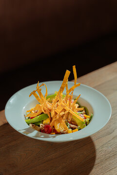 Food presentation of colorful salad with crispy garnish in a white