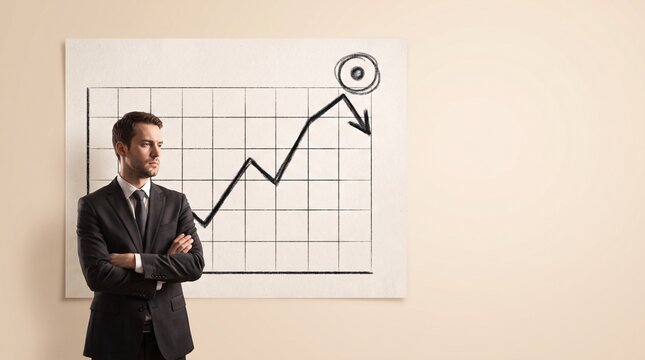 Concerned Businessman Standing Beside A Failing Business Growth Chart