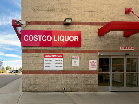 Calgary, AB, Canada. September 29, 2026. Exterior entrance and operating hours sign of a Costco Liquor store building in daylight.