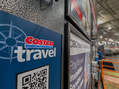 Calgary, AB, Canada. September 29, 2026. Close-up of Costco Travel sign and promotional displays inside a retail store.