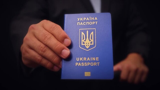 Ukrainian Passport Held In Hand Close Up
