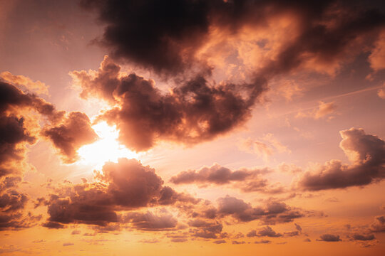 Glowing Sunset Clouds in Soft Pink and Orange Sky