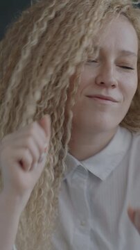 Slow motion portrait of carefree young woman dancing having fun on black studio background. People and good mood concept.