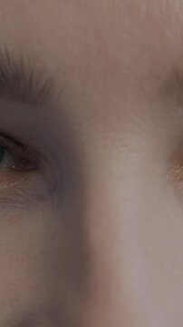 Close-up portrait of joyful female eyes looking at camera with happy expression. Individuality and human body part concept.