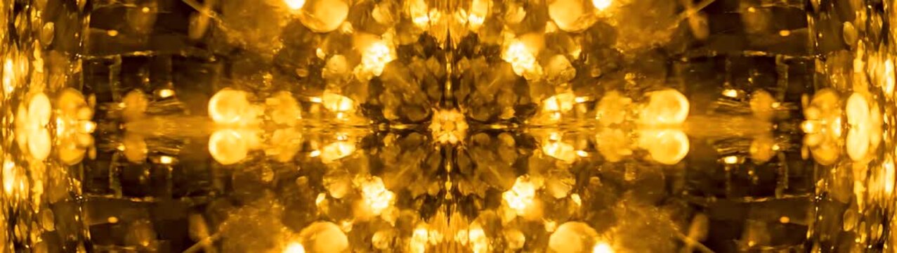 Luxury celebration and festive atmosphere golden bokeh lights background with shimmering particles and soft glowing lens flare abstract motion.