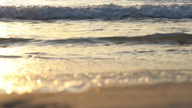 Captivating Serenity of Shoreline Waves at Sunset, as Gentle Surf Meets Soft Golden Sands on a Peaceful Beach Escape