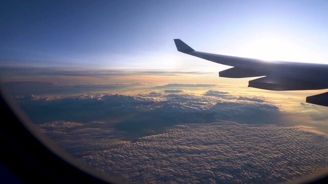Breathtaking Aerial View from an Airplane Window Showcasing Cloudy Horizons and Serene Skies During Sunset
