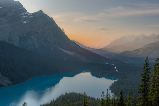 Mountain peak reflected in the still water of Peyto Lake at dusk, Banff National Park, Alberta, Canada