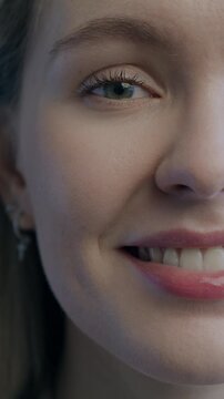 Portrait of cheerful young woman half face smiling with happiness on black color background. People and positive emotion concept.