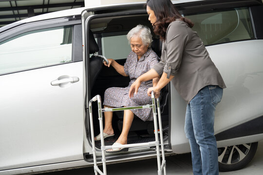 Asian senior woman patient sitting on walker prepare get to her car.