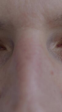 Close-up portrait of male eyes looking at camera with happy expression blinking. Positive emotion and human body part concept.