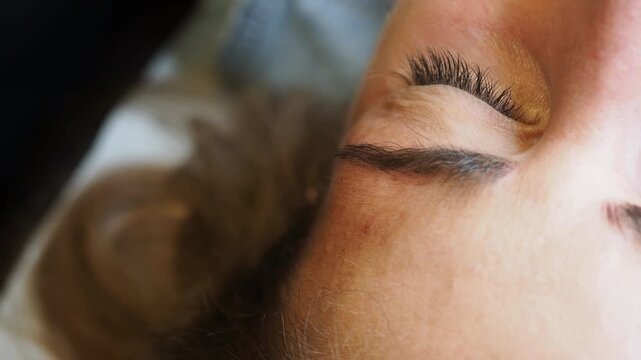 Eyebrow micropigmentation procedure on client before cosmetic tattooing with precision treatment tool