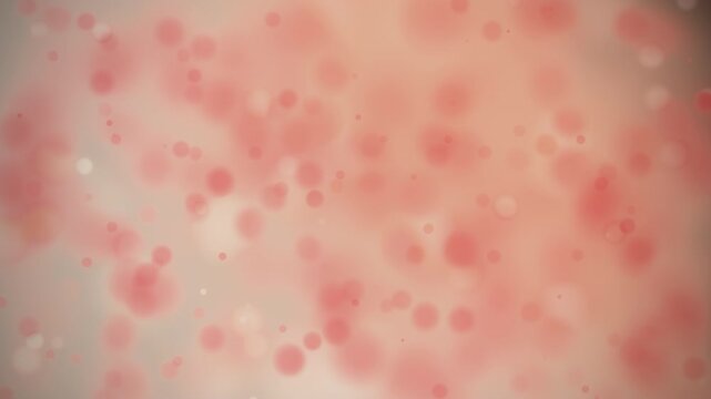 This abstract image features soft red and pink bokeh particles floating against a warm peach background for a romantic atmosphere.