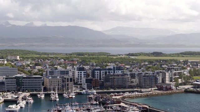 Drone trucking view of Bodo waterfront and coastline as airplane land at airport