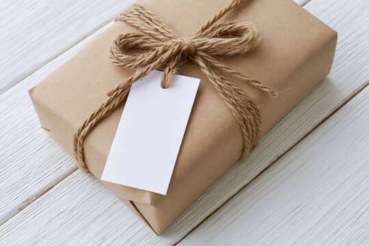 The Gift Box Wrapped in Kraft Paper with Twine and Blank Tag