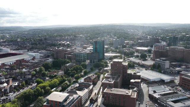 Aerial drone footage of Sheffield city centre, England, showing the Bramall Lane area and Sheldon Street. The drone slowly moves forward above the urban landscape, with a large roundabout visible in t
