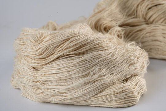 Natural fiber yarn textile thread beige soft material closeup craft handmade texture wool