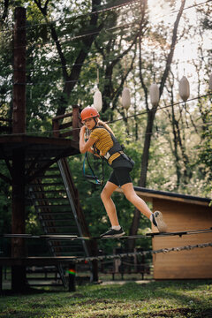 Teenager balancing on high ropes course adventure