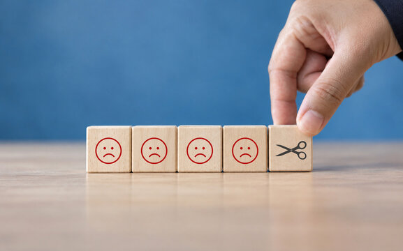 Reducing dissatisfied customers, managing complaints and claims. Bad ratings, bad reviews, customer dissatisfaction, angry. Wooden cube with negative, depression, sadness, mental problem, stress icon.