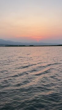 Serene Sunset Over Calm Lake Water