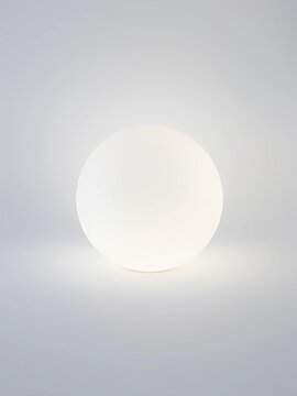 Smooth white sphere glows softly against light backdrop, clean, light