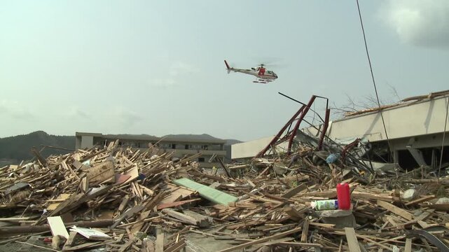 Helicopter Flies Over Disaster Zone In Aftermath Of Tsunami In Japan