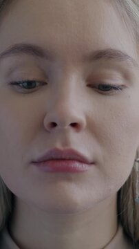 Slow motion portrait of unhappy young lady looking at camera expressing sadness on black color background. People and negative emotion concept.