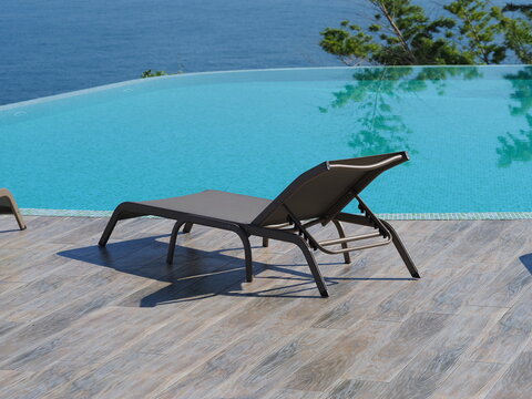 View of the infinity pool with sun loungers against the backdrop of the sea, and the hotel grounds.