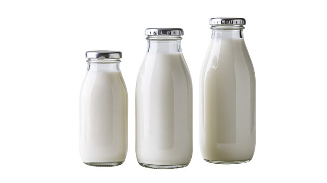 Three glass bottles of fresh white milk with silver metal caps