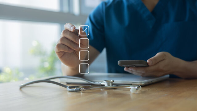 close up young general practitioner hand use stylus pen to check box on medical checklist or opd record to read and diagnose and assess about patient's symptom for healthy and lifestyle concept