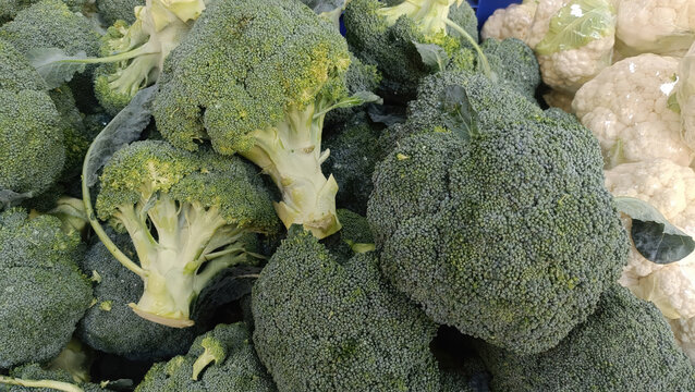 Fresh broccoli and cauliflower display with detailed green florets and creamy vegetable texture