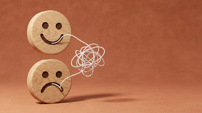 Wooden happy and sad faces linked by tangled thread, mood swings