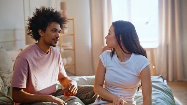 Young woman crying bedroom quarrel. Boyfriend apologizing comforting girlfriend.