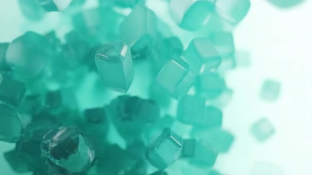 Macro shot of translucent green crystals or mineral cubes floating against a soft, light background. Ideal for concepts of purity, science, chemistry, or abstract backgrounds.