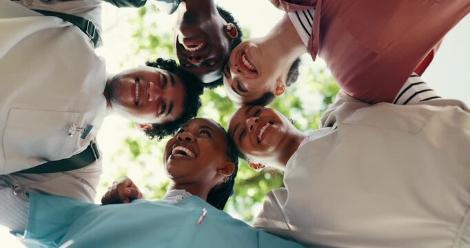 Support, friends or nursing student outdoor with huddle, bonding or motivation in medical education. Below, interns or happy people with embrace, group unity or encouragement in healthcare residency.