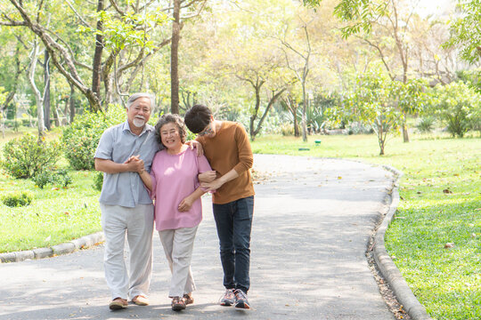 Happy asian family walking relax in the park together with smile on face