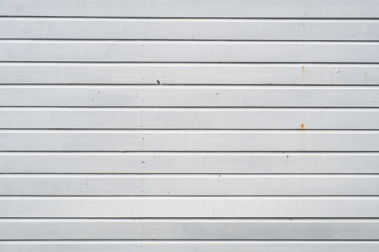 White painted horizontal wooden boards with small marks and rust stains
