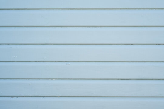 Light blue painted horizontal wooden boards with subtle wood grain