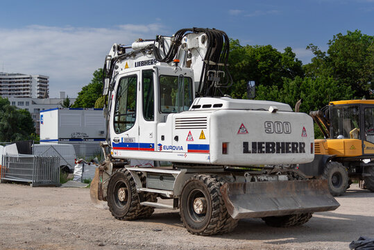 Nancy, France - June 22nd 2019 : View of a 17-tonne white wheeled excavator Liebherr A 900 C Litronic for earthworks on a construction site.