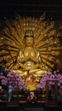 Inside traditional ancient chinese temple, statue of multi-armed god Bodhisattva, oriental religion and beliefs. Thousand-armed Guanyin, praying in buddist pagoda, taoism and chinese folk religion