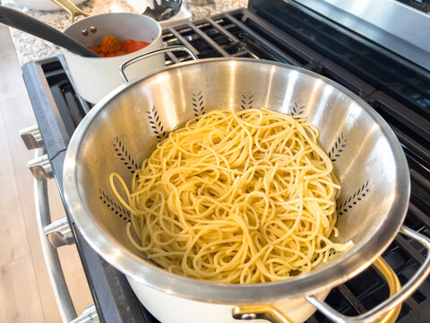Spaghetti Draining in Colander on Stove