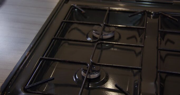 Close-up shot of Pan of Boiling water being taken off small gas jet hob. On a hob in a static caravan